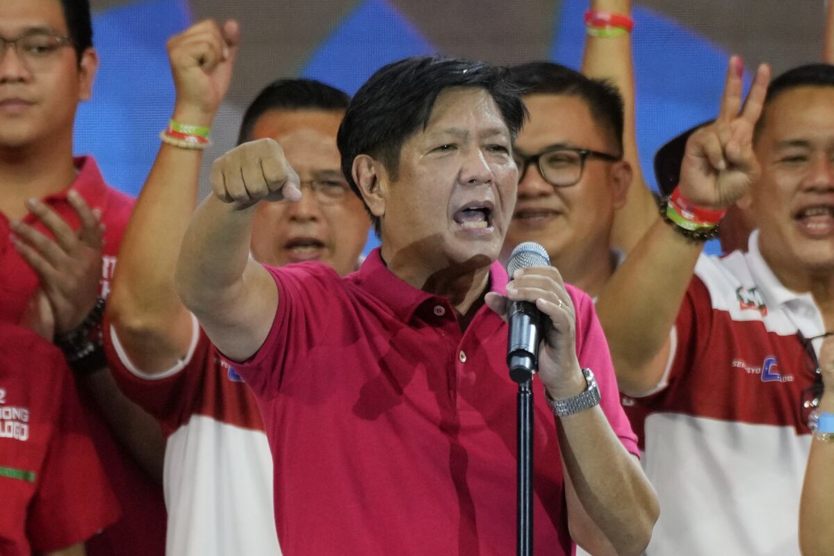 Presidential hopeful, former senator Ferdinand "Bongbong" Marcos Jr. gestures as he greets the crowd.