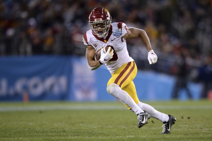 FILE - Southern California receiver Amon-Ra St. Brown runs with the ball during the second half of the Holiday Bowl NCAA college football game against Iowa in San Diego, in this Friday, Dec. 27, 2019, file photo. USC plays Arizona State at 9 a.m. Pacific time on Saturday, Nov. 7, 2020. (AP Photo/Orlando Ramirez, File)
