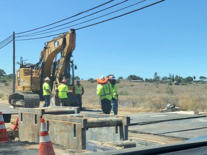 Crews work on a San Diego Gas & Electric project on Coal Grade Road in Valley Center on Tuesday.  