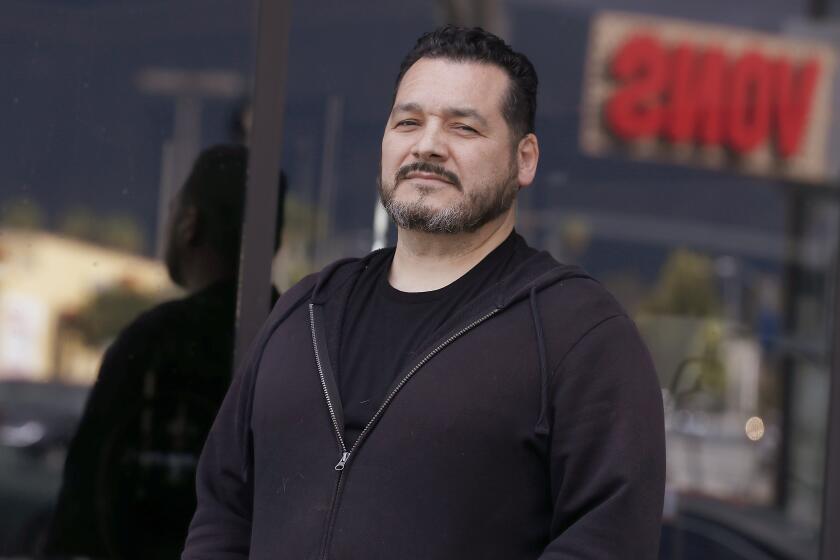 PASADENA, CALIF. -MAR. 24, 2020. Grocery store employee Raymond Lopez is on the front lines of our daily battle against a new enemy: coronavirus pandemic panic. He has worked for Vons for 33 years. (Luis Sinco/Los Angeles Times)