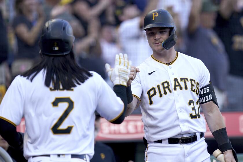 Pittsburgh Pirates' Connor Joe, left, celebrates with Henry Davis after scoring on a double hit by Miguel Andujar against the Miami Marlins during the eighth inning of a baseball game in Pittsburgh, Sunday, Oct. 1, 2023. (AP Photo/Matt Freed)