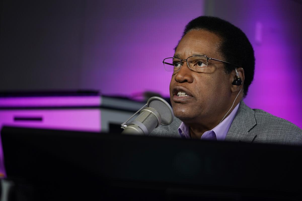 Larry Elder talks into a microphone