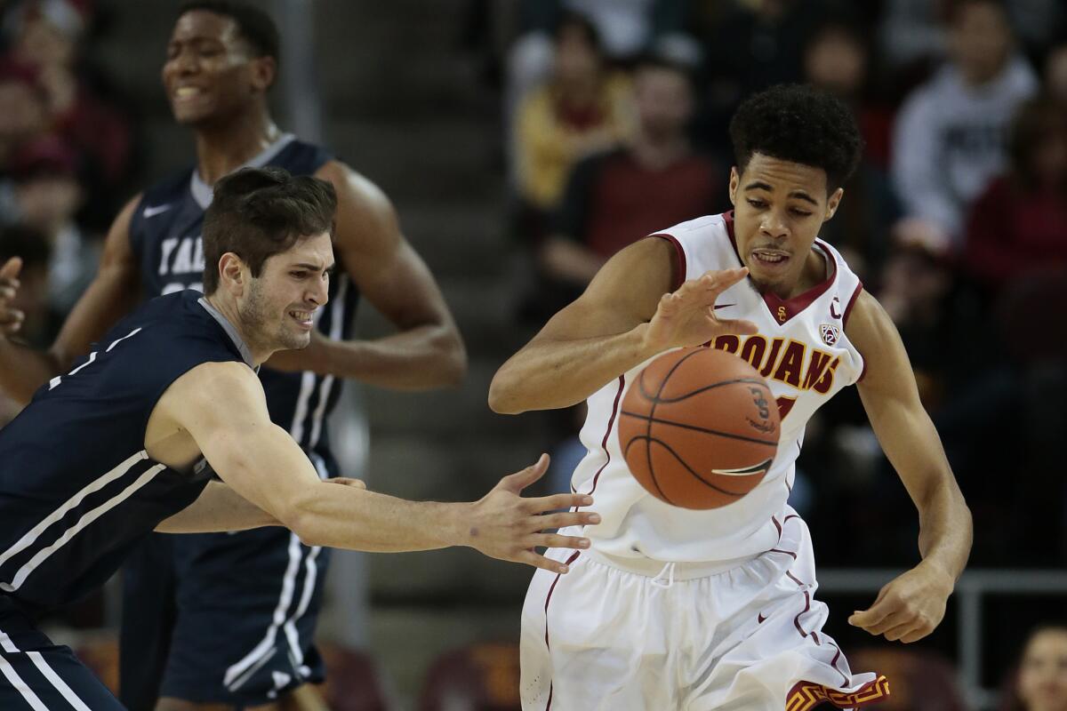 USC guard Malik Marquetti steals the ball from Yale guard Anthony Dallier during the second half of a 68-56 Trojans win at the Galen Center.