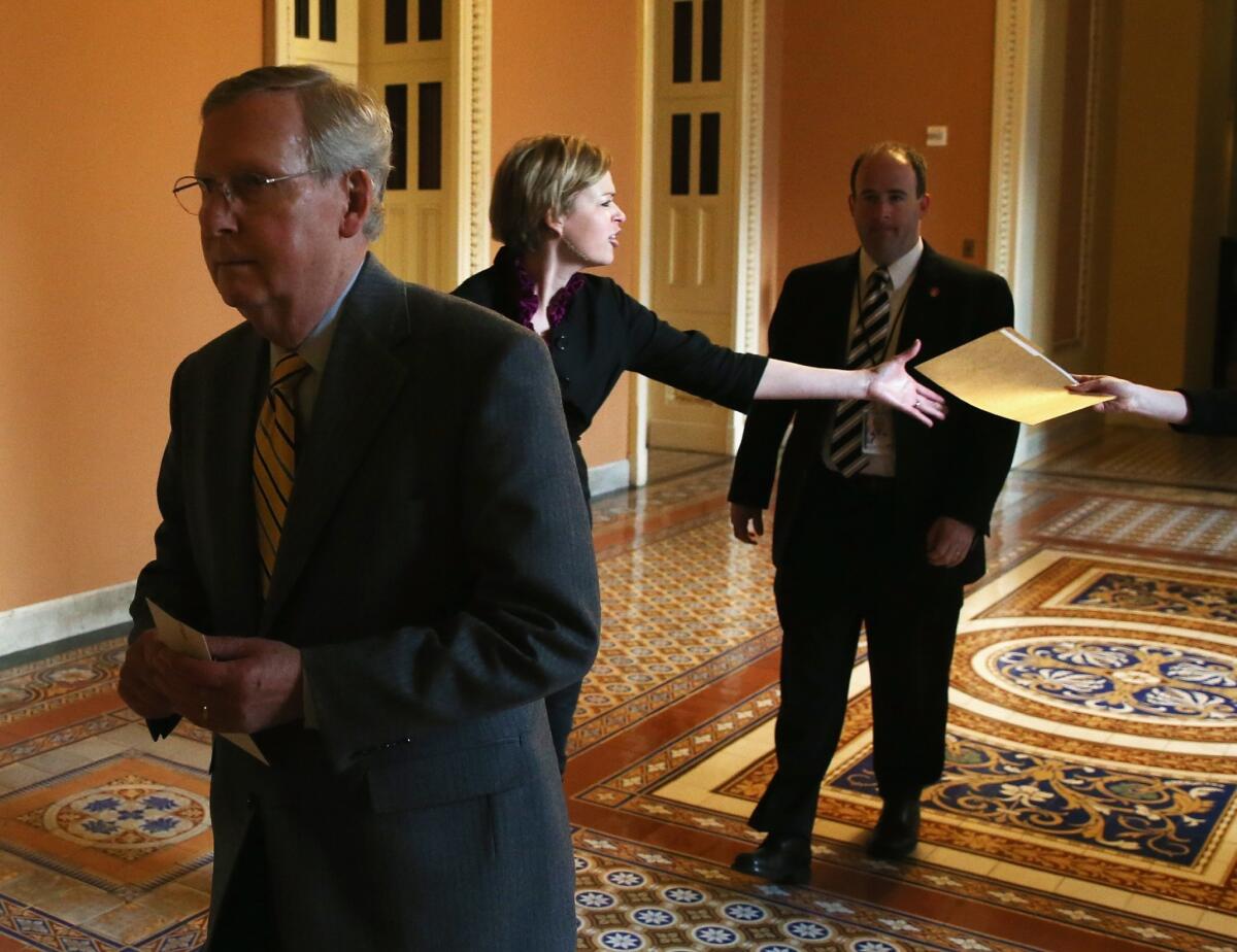 Senate Majority Leader Mitch McConnell (R-Ky.) walks to a vote in the Senate chamber on March 26.