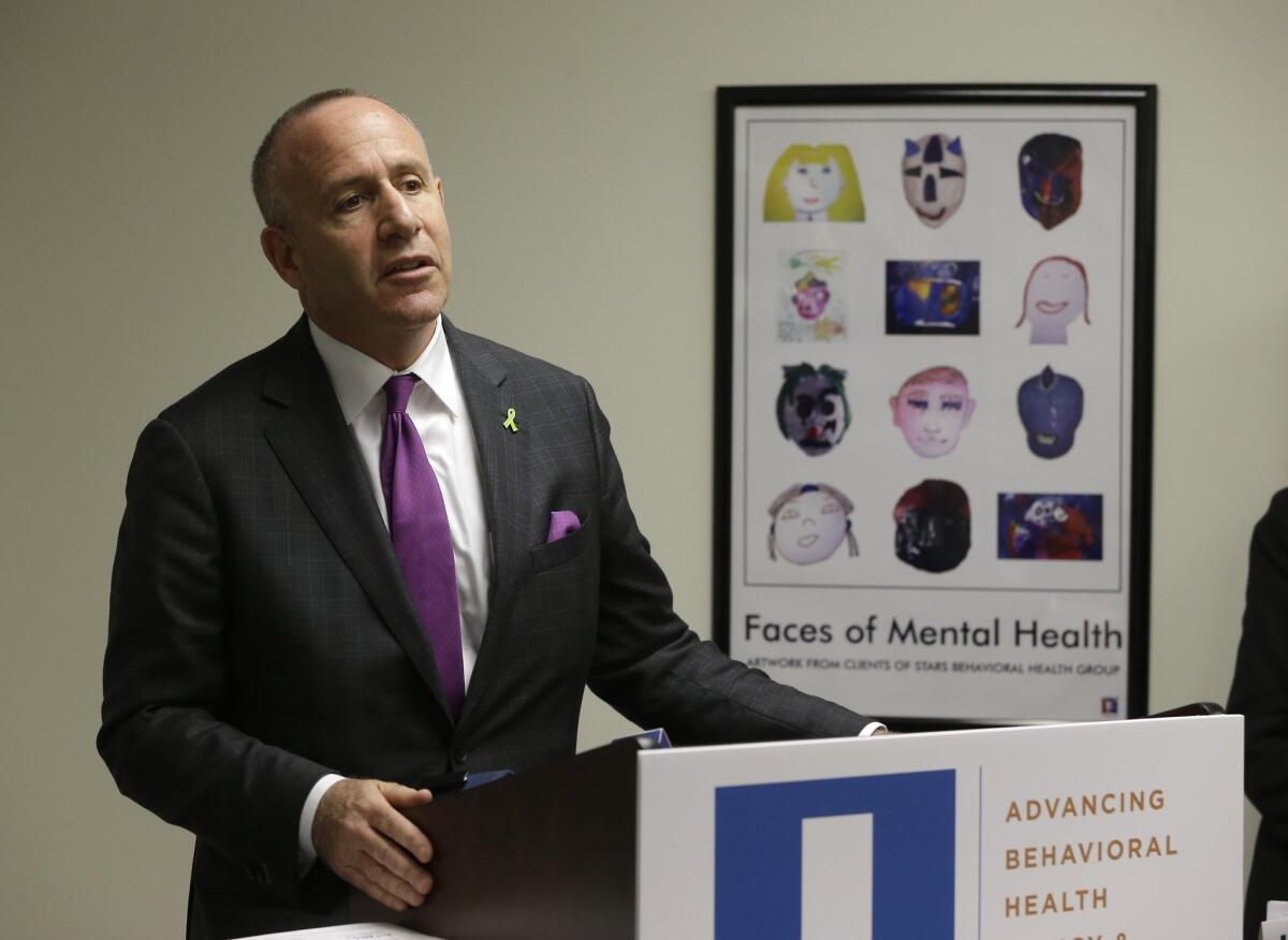 Former Senate President Pro Tem Darrell Steinberg discusses a report on his mental health tax initative during a news conference in Sacramento.