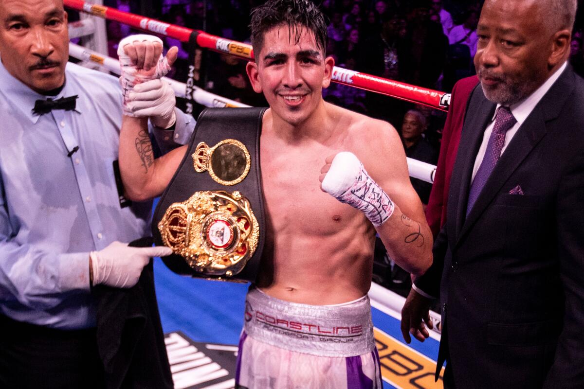 Leo Santa Cruz poses after his victory against Miguel Flores during their World Boxing Association super featherweight championship fight on Saturday in Las Vegas.