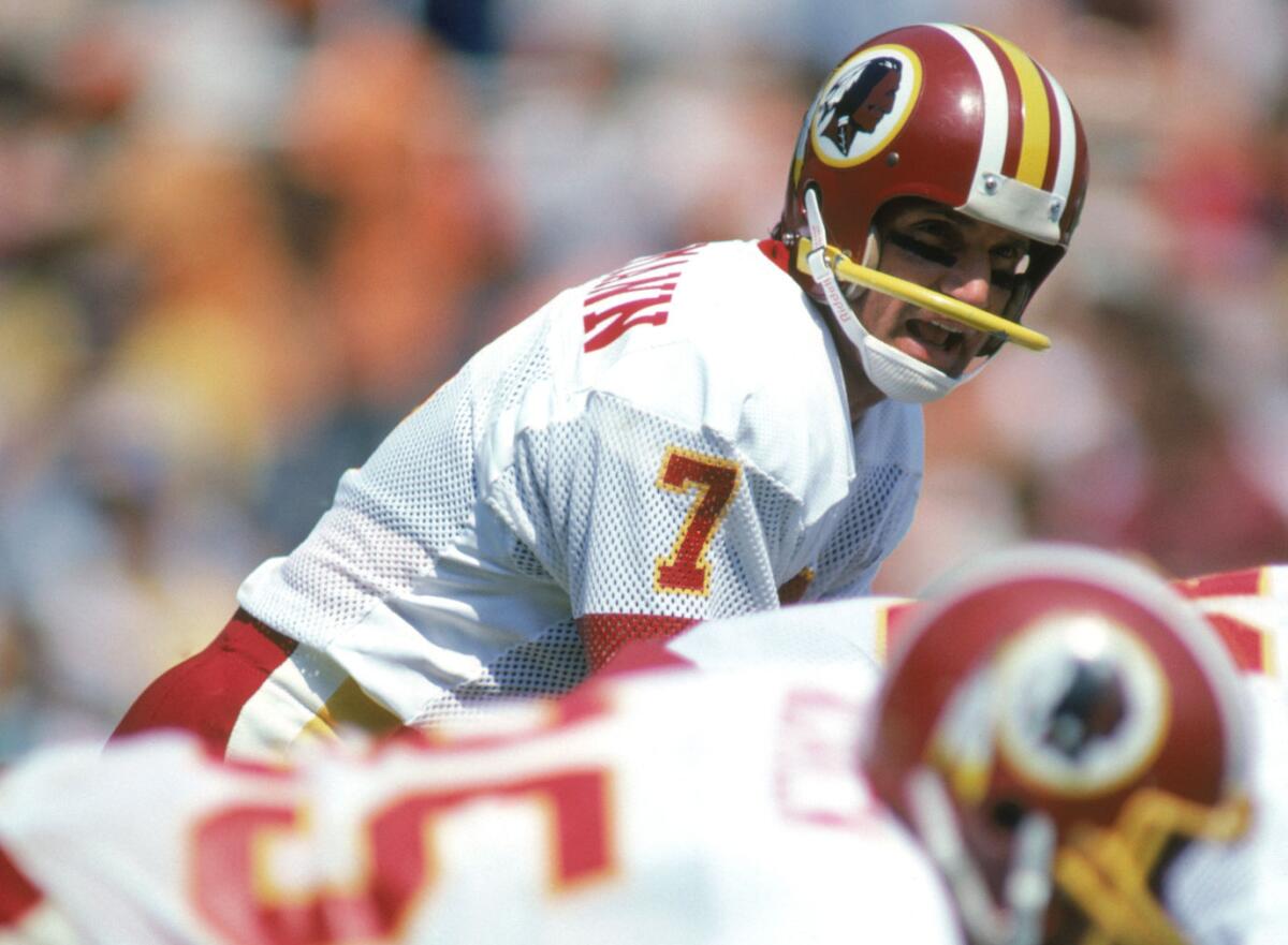 Washington Redskins quarterback Joe Theismann at the line of scrimmage.