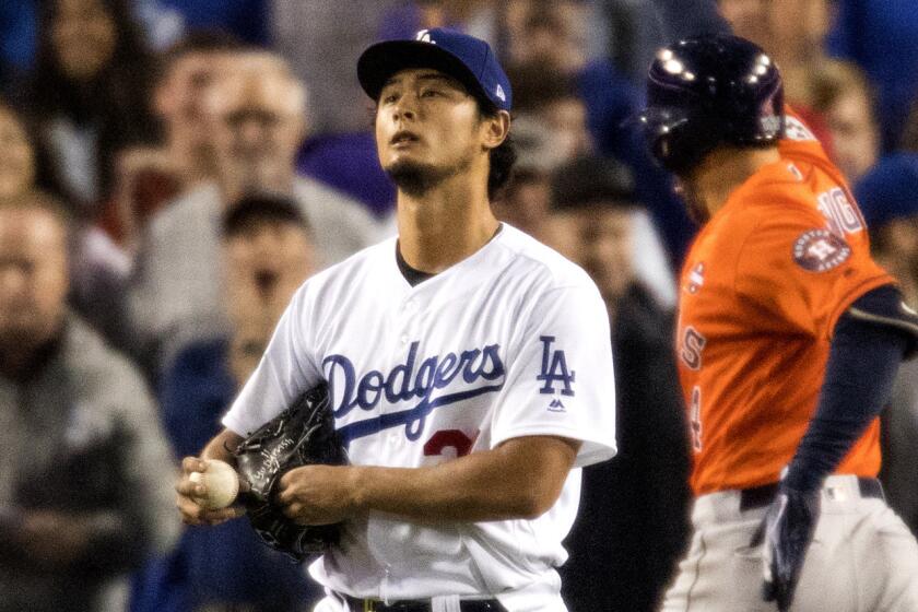 LOS ANGELES, CA - NOVEMBER 1, 2017: Los Angeles Dodgers starting pitcher Yu Darvish (21) stares into the outfield as Houston Astros center fielder George Springer (4) reaches home plate after hitting a 2-run homer to give the Astros a 5-0 lead in the second inning of game 7 of the World Series at Dodger Stadium on November 1, 2017 in Los Angeles, California.(Gina Ferazzi / Los Angeles Times)
