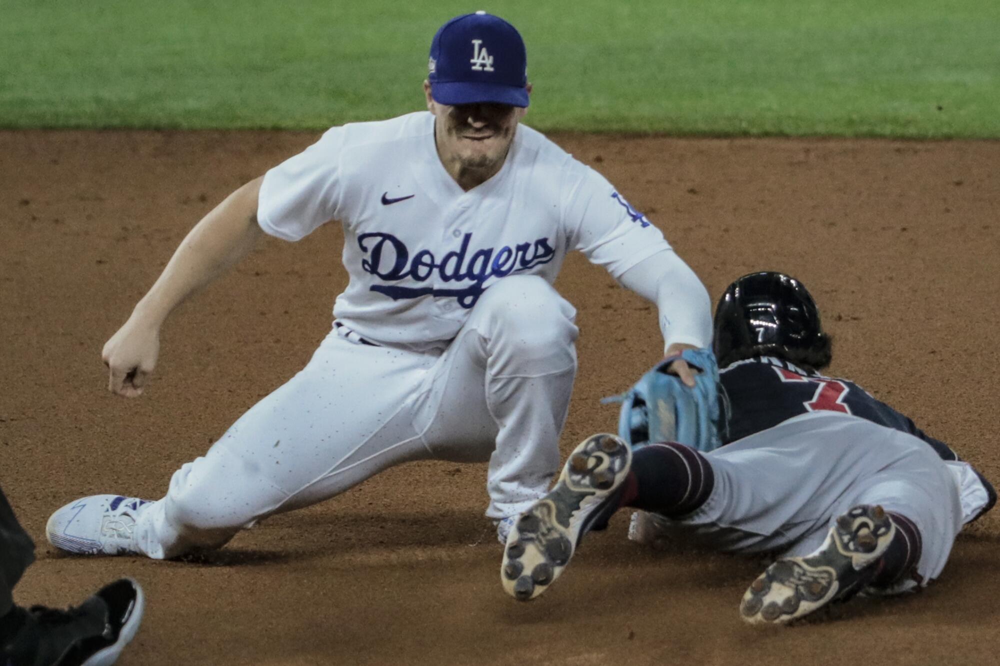 Atlanta Braves baserunner Dansby Swanson beats the tag of Dodgers second baseman Kiké Hernández to steal second.