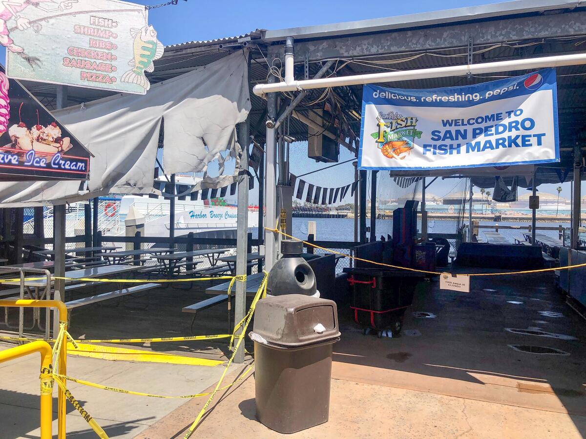 Waterside patio seating is taped off for now at San Pedro Fish Market.