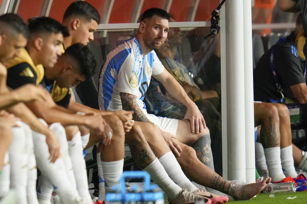 Argentina's Lionel Messi sits on the bench.