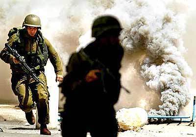 Israeli soldiers set off smoke bombs.
