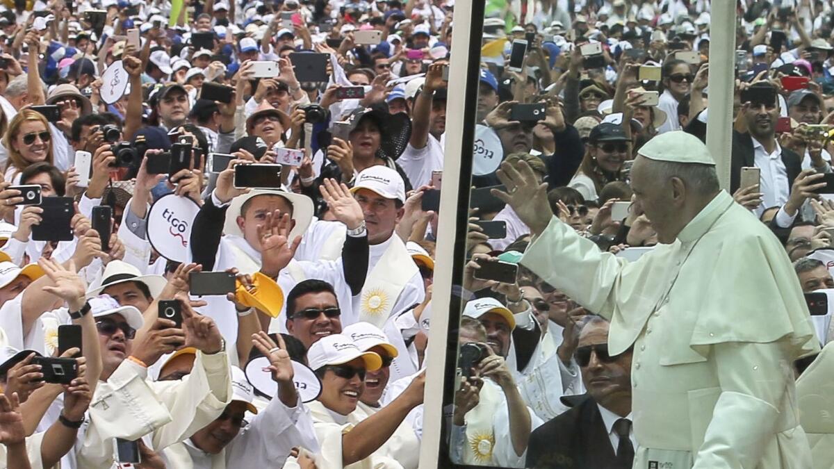 Pope Francis waves at the crowd as he arrives at the Enrique Olaya Herrera airport in Medellin, Colombia, on Sept. 9, 2017.