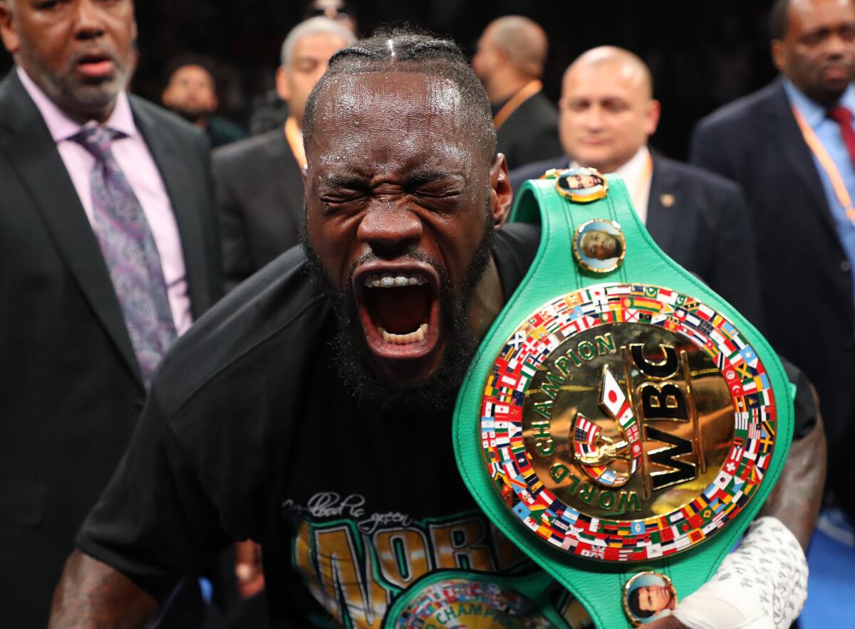Deontay Wilder celebrates after knocking out Dominic Breazeale.