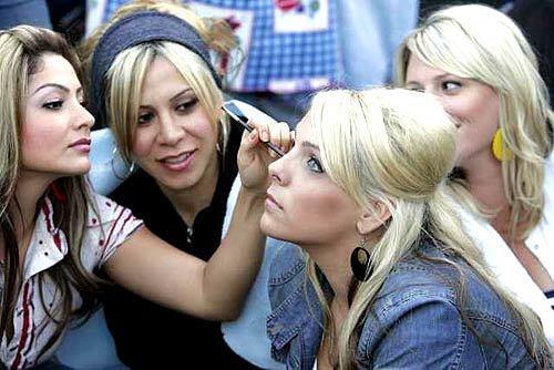 Lucy Hart, 22, of Montebello applies makeup to Sacha White, 22, of Bakersfield as friends Jennifer Moreno, 25, second from left, of Montebello and Summer Lincoln, 28, of Bakersfield look on. A throng of hopefuls showed up before dawn to audition for "American Idol" at the Rose Bowl in Pasadena on Tuesday.