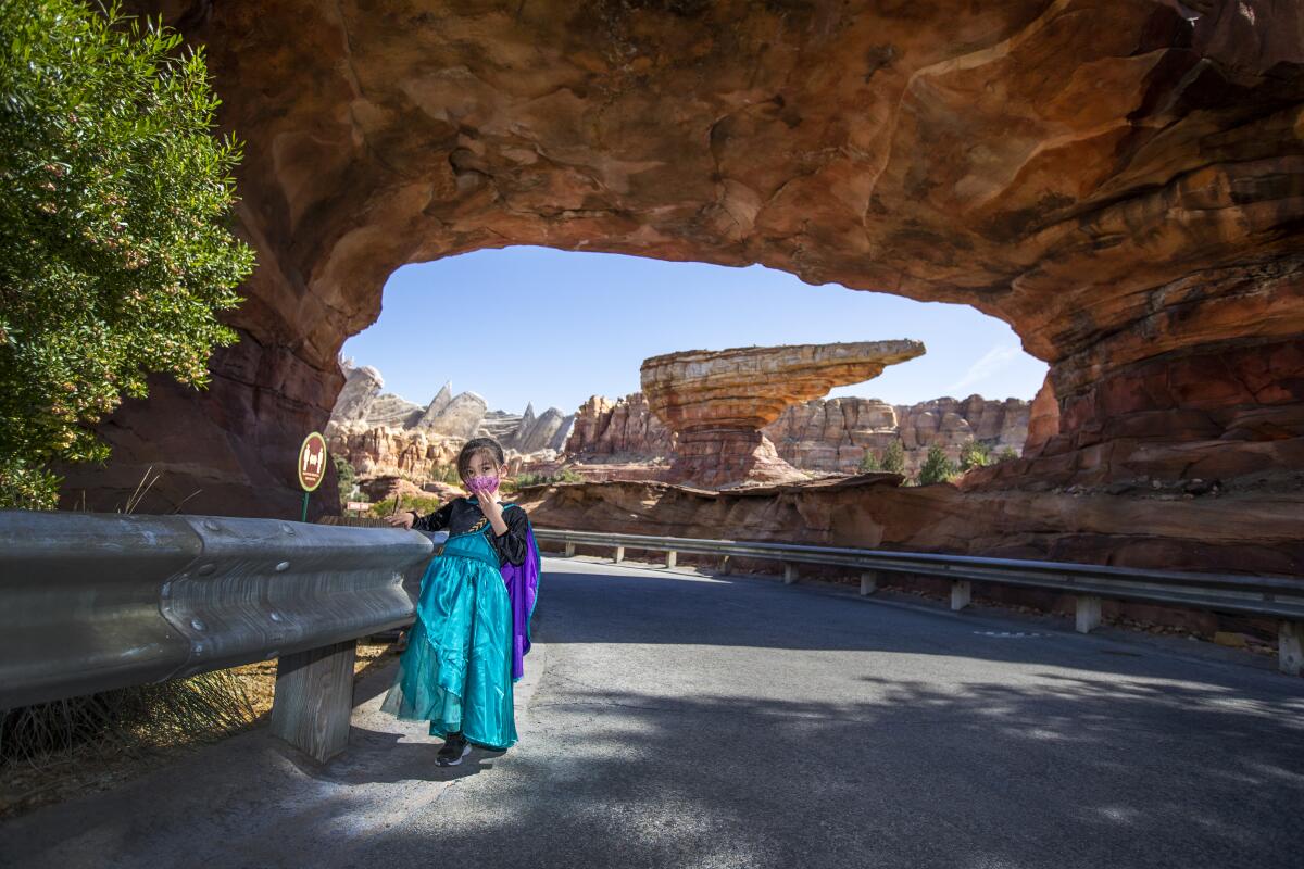 Ally Carrasco poses for a photo at the scenic entrance to Cars Land