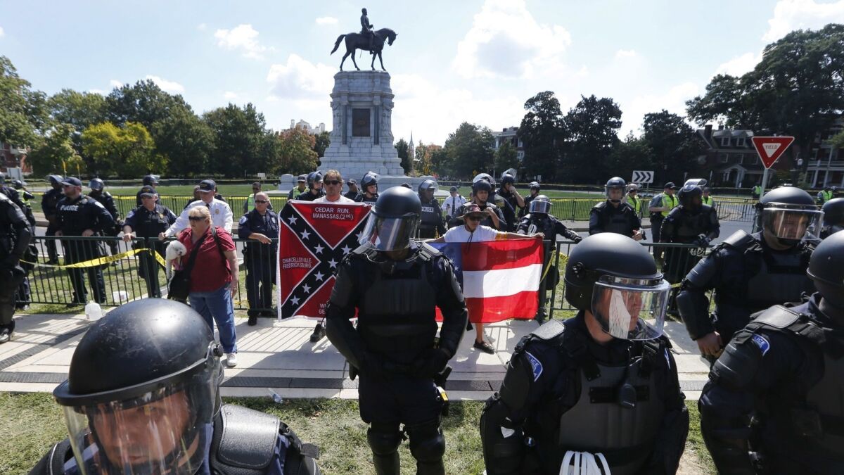 Virginia State Police keep a handful of protesters separated from counter-demonstrators in front of the statue of Confederate General Robert E. Lee in Richmond, Va., on Sept. 16, 2017.