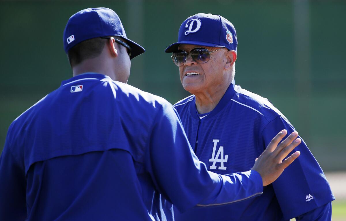 Maury Wills, right, speaks with a fellow Dodgers coach during a spring training baseball workout on Feb. 22.