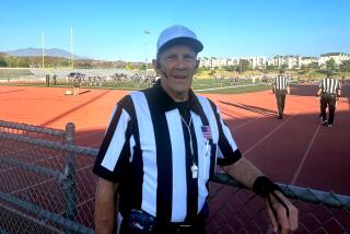 Brian Brennan poses for a photo before a high school football game.