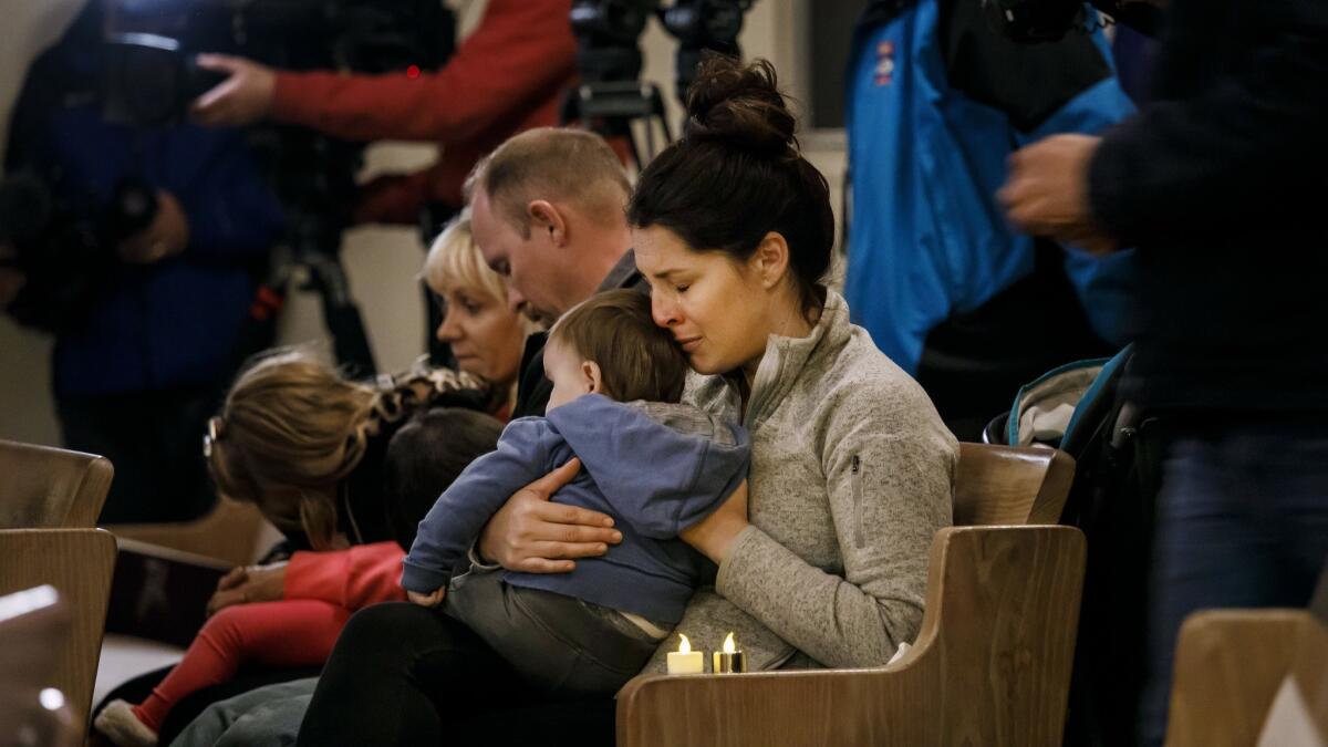 Kristy Collins embraces her 9-month-old son Andrew during a vigil for the those who died in the Camp fire — and prayers for the first responders — at First Christian Church in Chico, Calif., on Nov. 18.