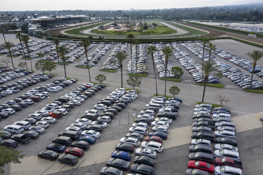 Cars are stored at the Santa Anita racetrack parking lot. 