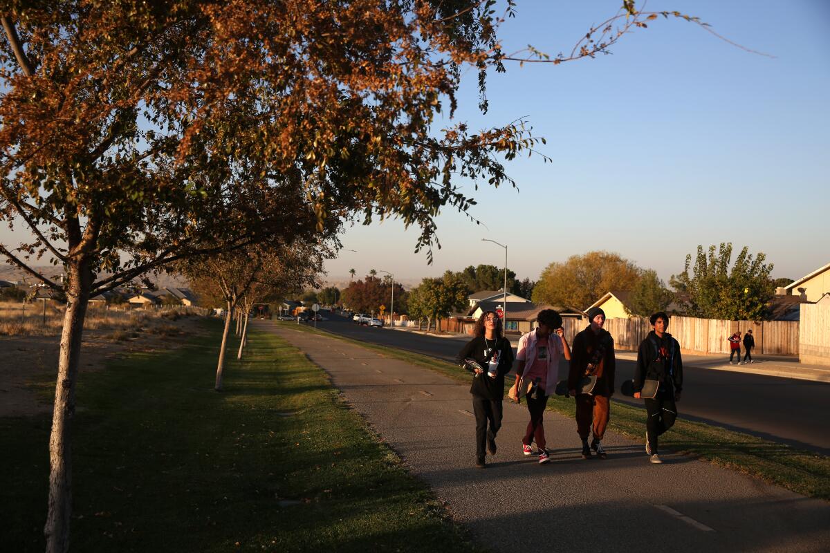 Young people walk down one of the quiet streets in Taft, Calif.