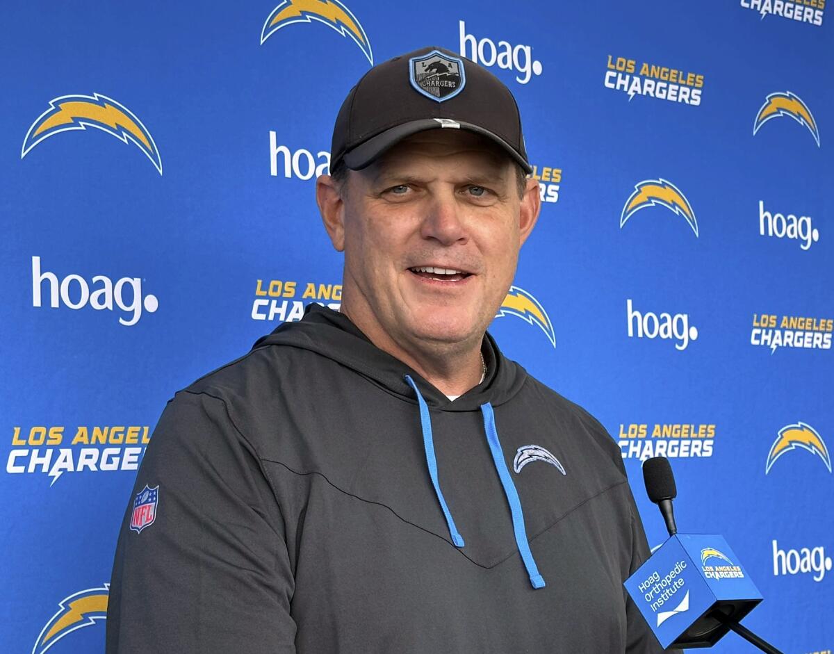Chargers interim coach Giff Smith talks to the media after practice on Tuesday.