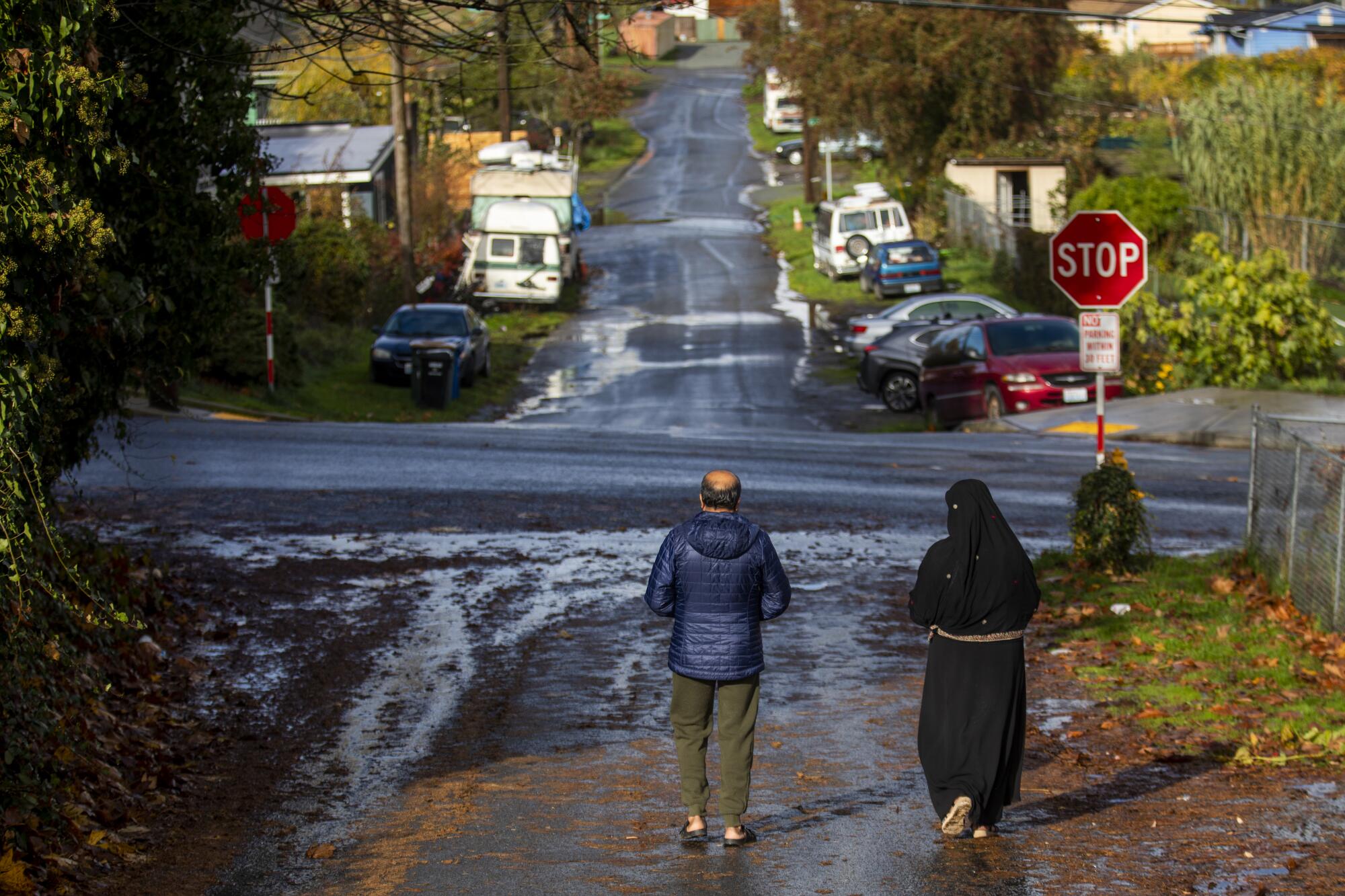 Two Afghan refugees walk down a street in Seattle.