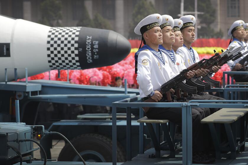 FILE - In this April 15, 2017, file photo, navy personnel sit in front of a submarine-launched "Pukguksong" ballistic missile (SLBM) as it is paraded across Kim Il Sung Square in Pyongyang, North Korea. North Korea could soon conduct its first underwater-launched ballistic missile test in about a year, South Korea’s military said Wednesday, Sept. 16, 2020, amid long-stalled nuclear talks between the North and the United States. (AP Photo/Wong Maye-E, File)