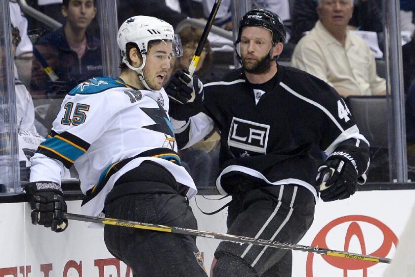 Defenseman Robyn Regehr, right, who has given the Kings a more-physical presence, has signed a two-contract extension.