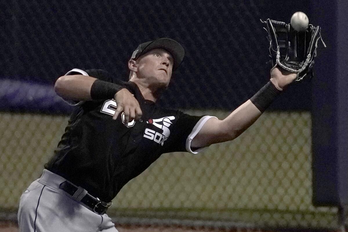 Seattle Mariners first baseman Ty France, right, grabs the hat of