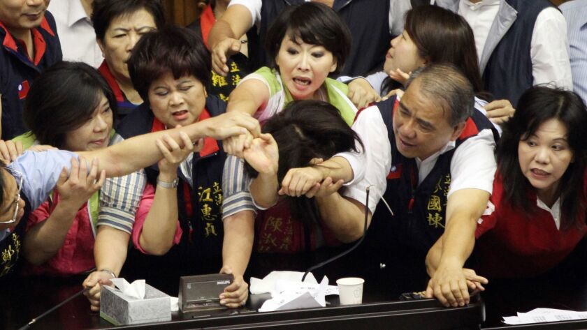 Legislators in Taiwan fight over the parliament's podium in 2013.