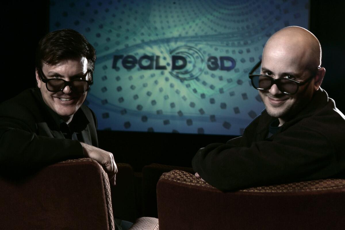 RealD founders Michael Lewis, left, and Josh Greer wear 3-D glasses inside their theater at their Beverly Hills headquarters.