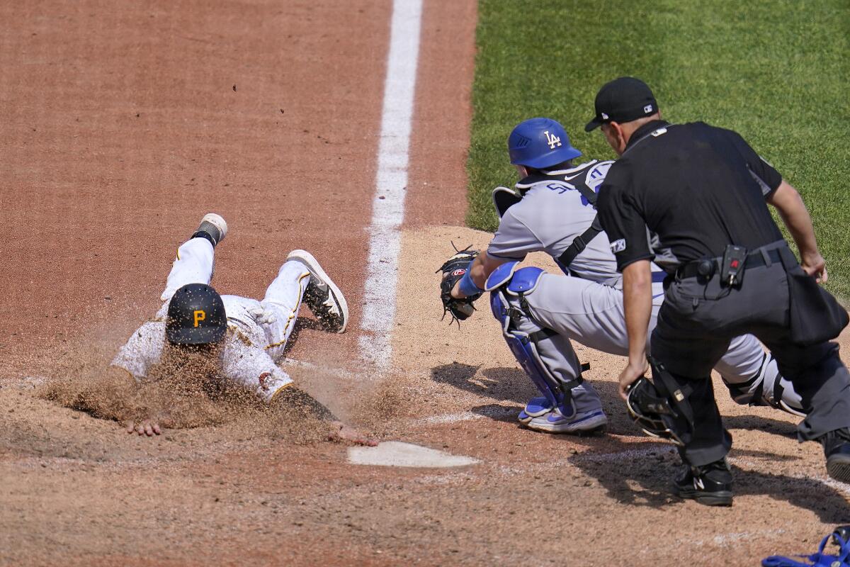 Pirates' Josh VanMeter scores past Dodgers catcher Will Smith on a fielder's choice.