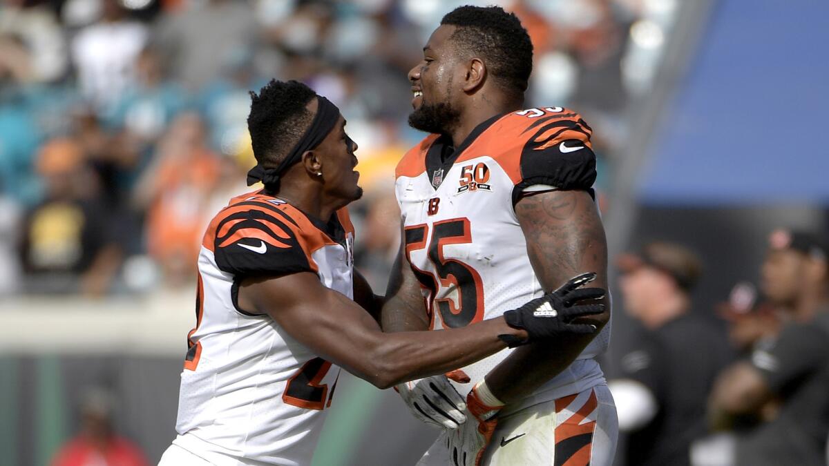 Bengals cornerback William Jackson keeps linebacker Vontaze Burfict (55) away from a fight involving a teammate during their game against the Jaguars.