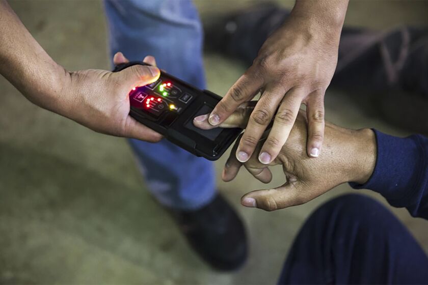 This undated photo obtained from Immigration and Customs Enforcement (ICE) shows a NeoScan 45 fingerprint scanner. The device, paired with an app known as EDDIE, is used by ICE to run remote ID checks. The app has been a core tool in President Donald Trump’s deportation crackdown, according to a new report based on a Freedom of Information Act lawsuit. (Immigration and Customs Enforcement via AP)