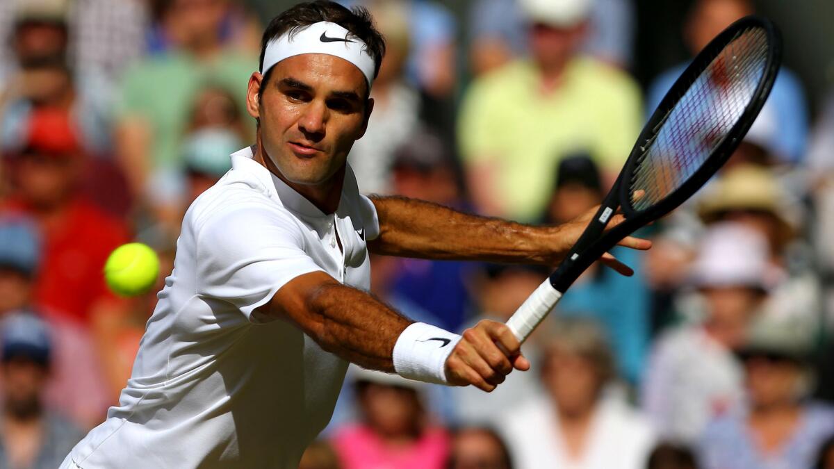 Roger Federer returns a shot against Tomas Berdych during their semifinal match Friday at Wimbledon.