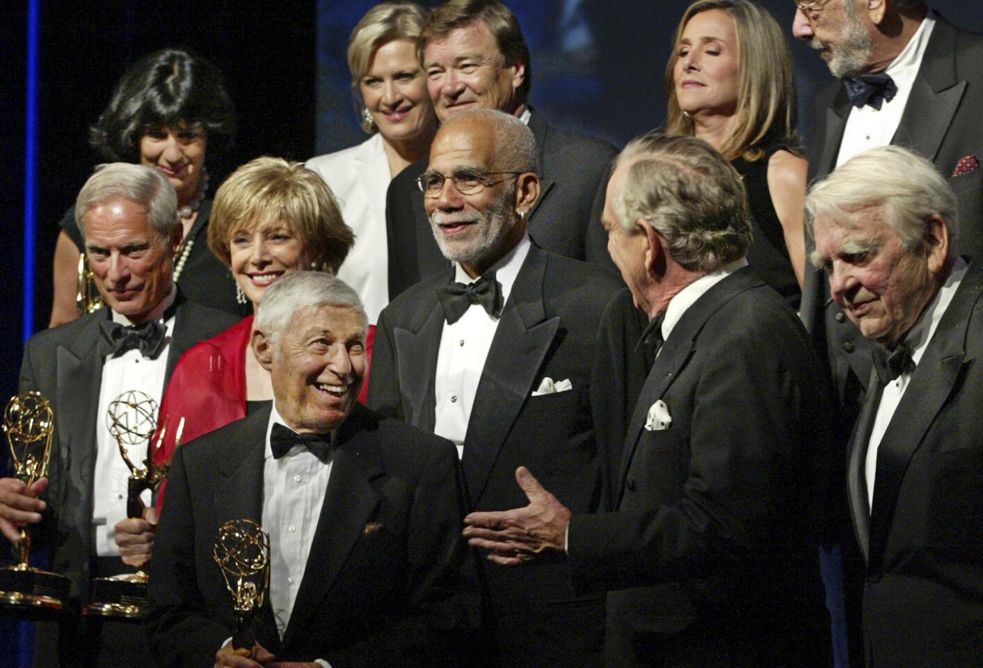 Bob Simon, left, and current and former "60 Minutes" colleagues at the time accept a lifetime achievement award at the News and Documentary Emmy Awards in New York in 2003.