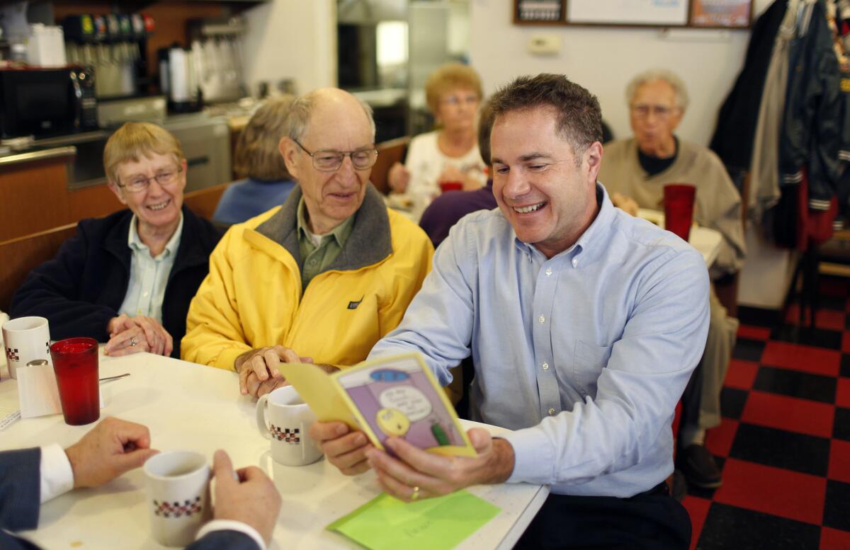 Rep. Bruce Braley, the Democratic candidate for Senate in Iowa, looks over a birthday card in an appearance Thursday at Morg's Diner in Waterloo.