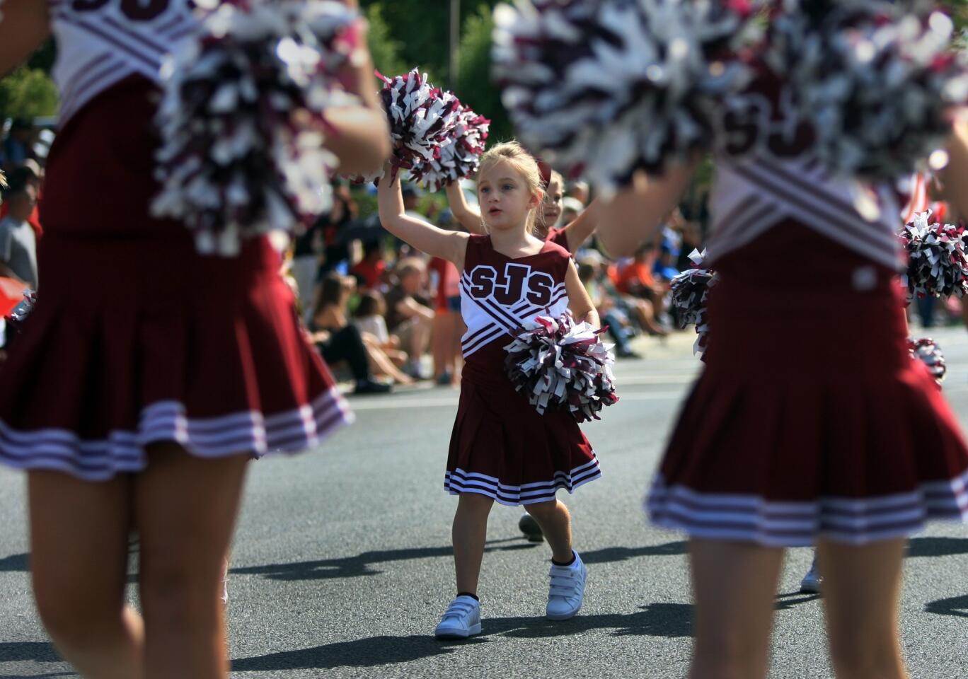 Cheerleaders from St. Jude School walk and cheer along Thousand Oaks Boulevard during the city's 50th anniversary parade on Saturday.