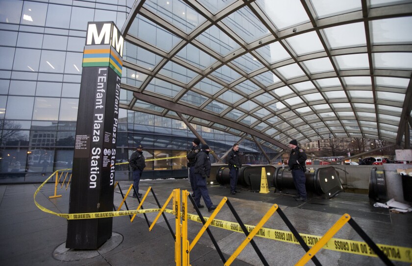 Metro Transit police secure the entrance to L'Enfant Plaza Station in Washington on Jan. 12 after smoke filled a nearby tunnel.