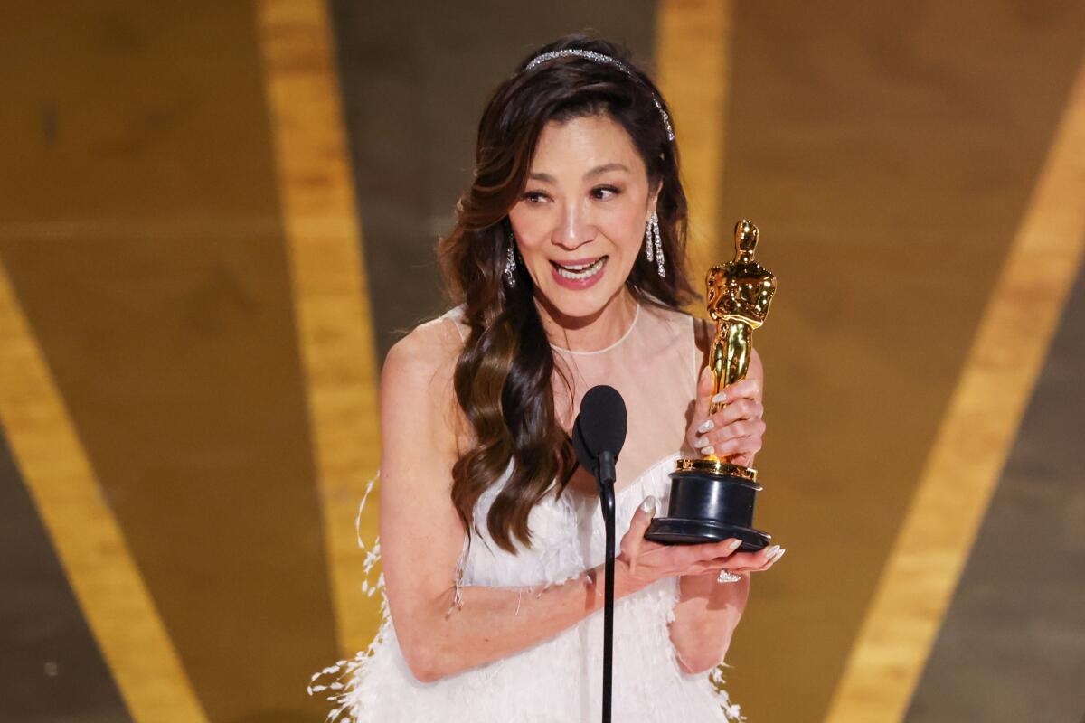 A woman onstage accepting an Oscar.