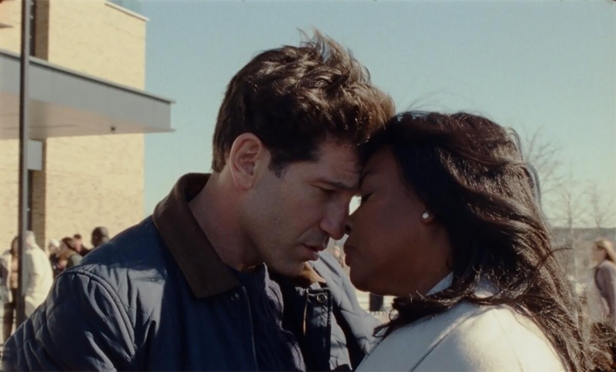 Jon Bernthal and Aunjanue Ellis touch foreheads in a scene from "Origin."