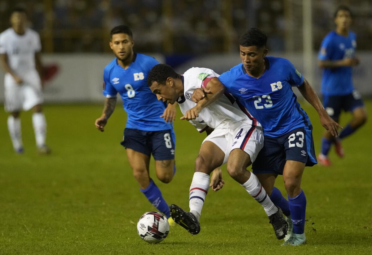 United States' Tyler Adams and El Salvador's Melvin Cartagena fight for the ball.