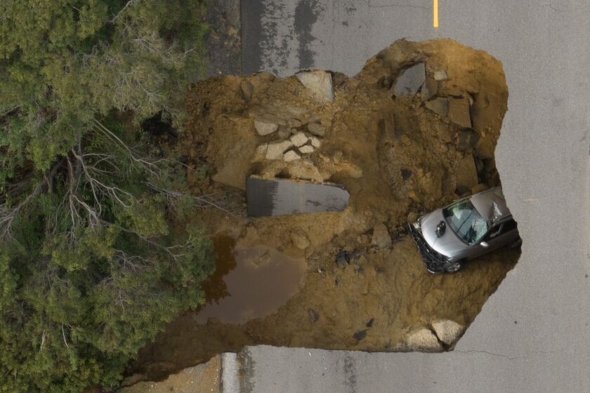 CHATSWORTH, CA - JANUARY 10: Two vehicles fell into a sinkhole on Iverson Road in Chatsworth trapping four people. Photographed at Iverson Road on Tuesday, Jan. 10, 2023 in Chatsworth, CA. (Myung J. Chun / Los Angeles Times)