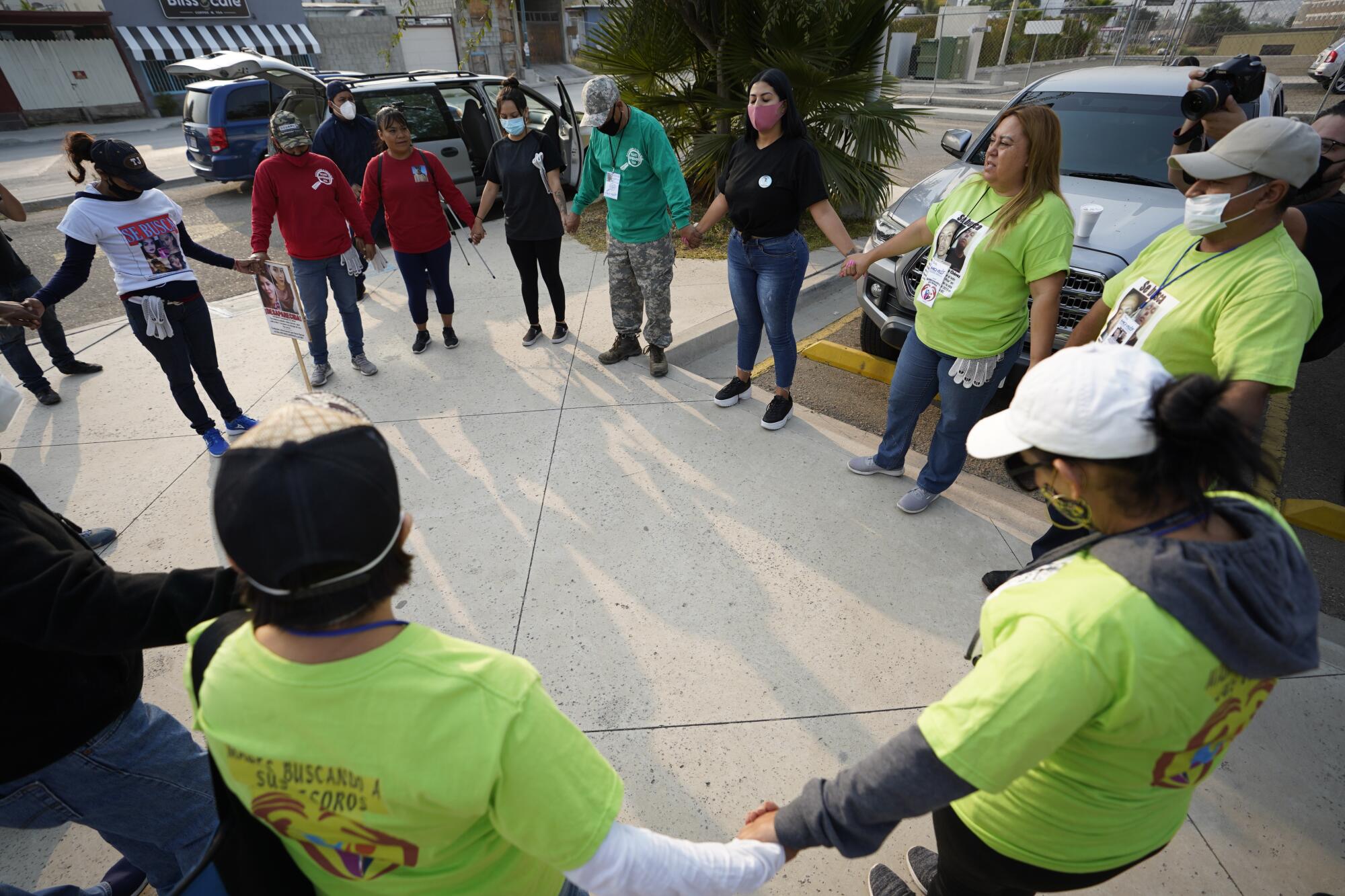 Parents of missing childen form a circle and pray.