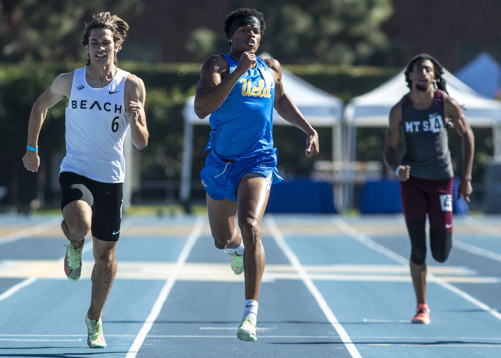 UCLA's Zaylon Thomas crosses the finish line in his heat of a 200-meter race.