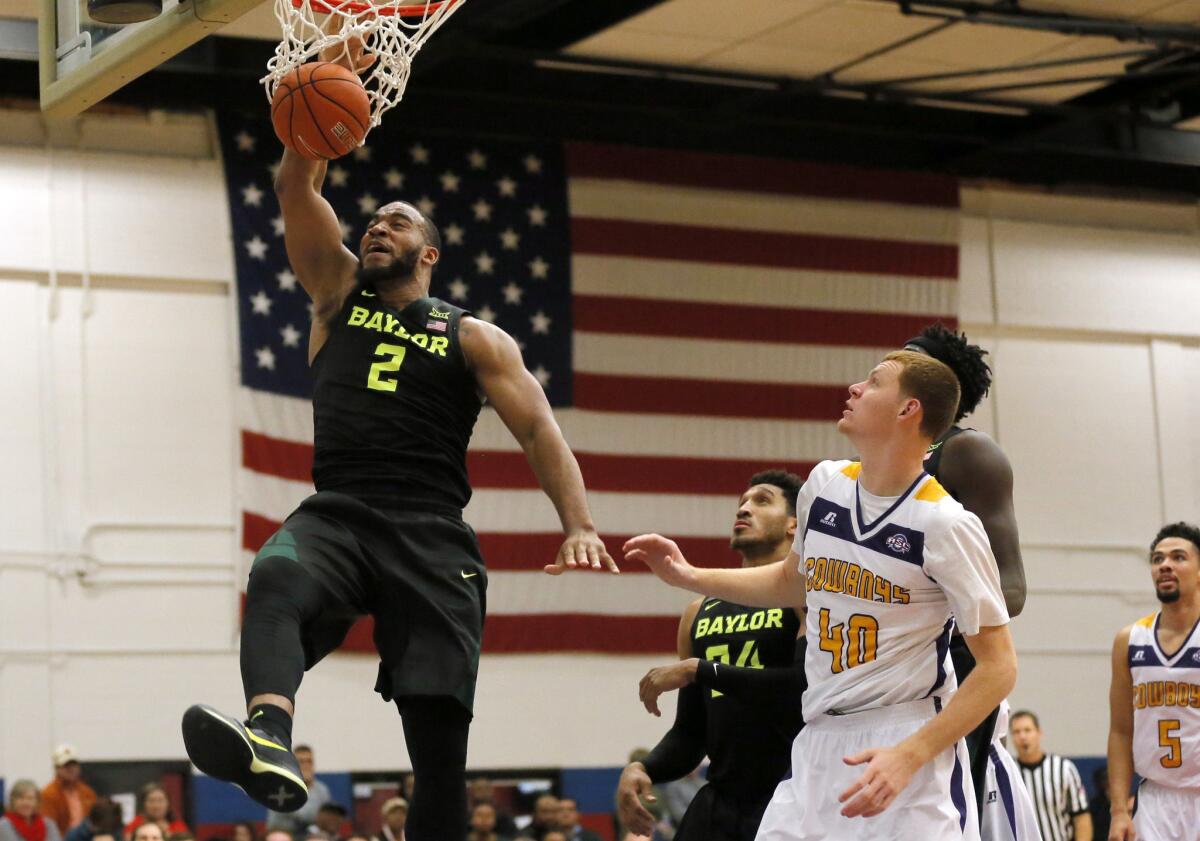 Baylor forward Rico Gathers (2) dunks as Hardin-Simmons' Justin Jones (40) watches during the second half a game held in Fort Hood, Texas. Baylor won 104-59.