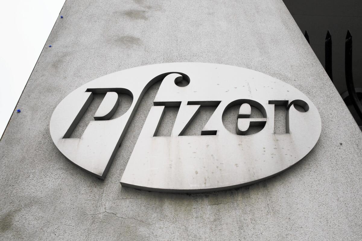 The Pfizer logo is displayed on the exterior of a former Pfizer factory in Brooklyn, N.Y.