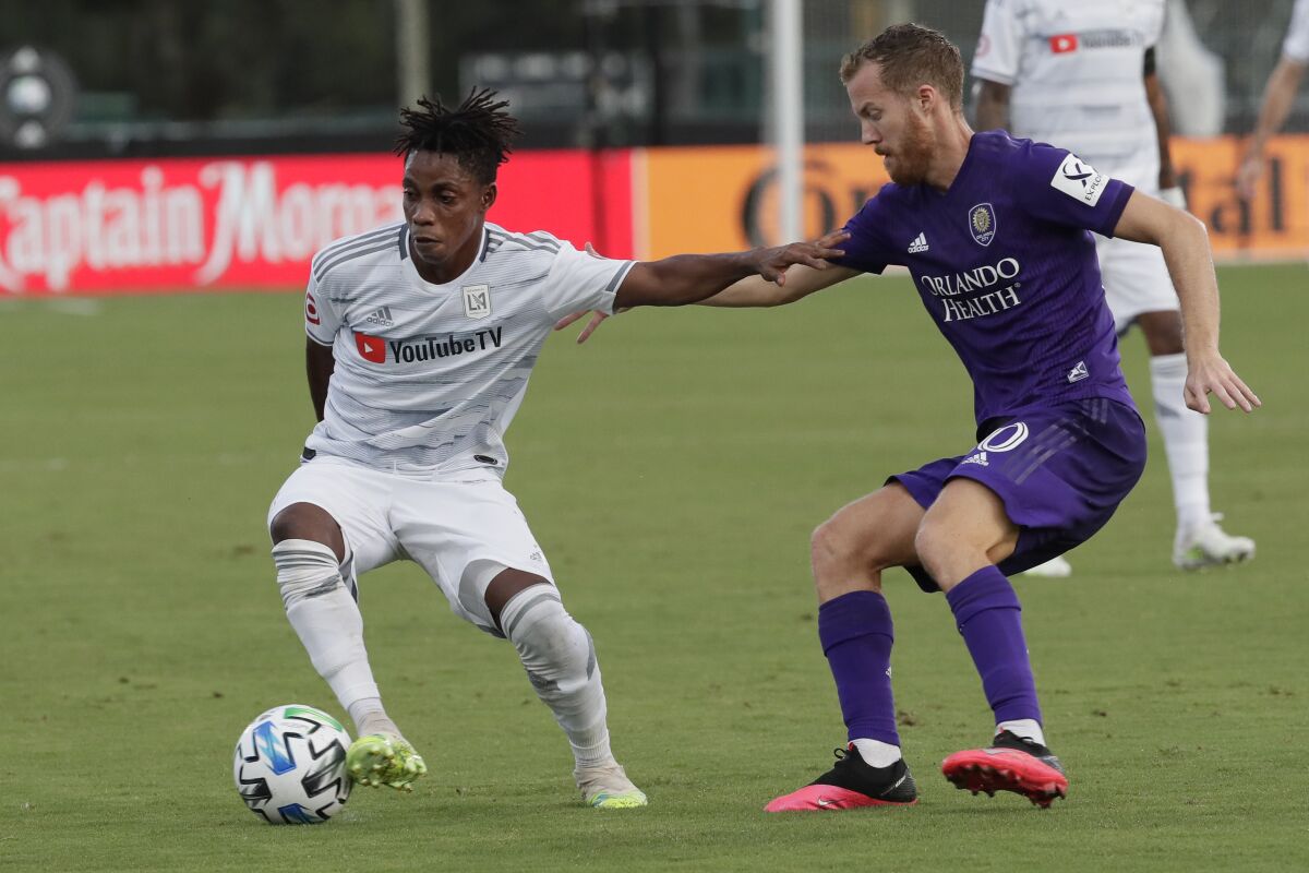Orlando City midfielder Oriol Rosell, right, and Los Angeles FC forward Latif Blessing get tangled